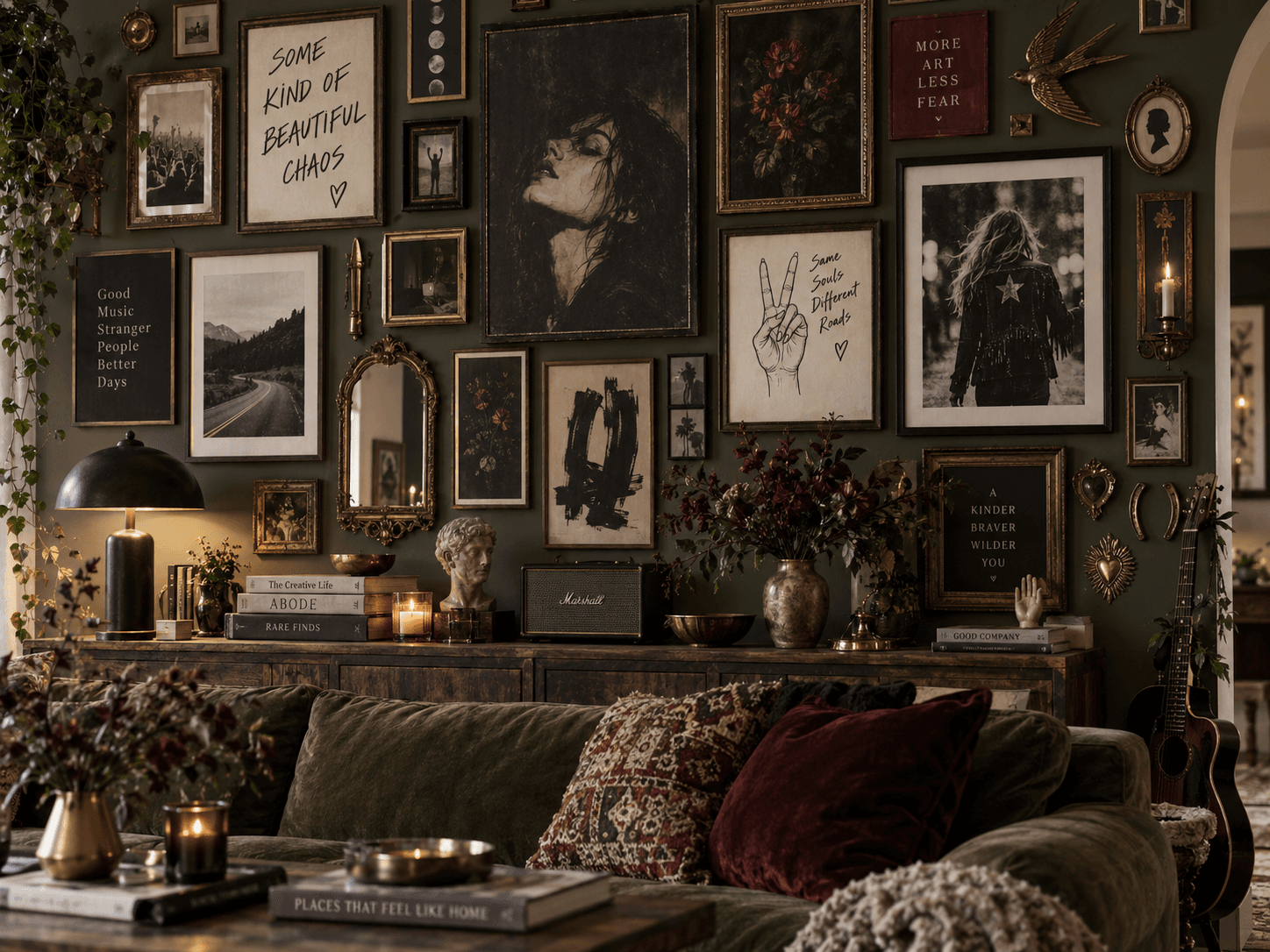 Eclectic maximalist gallery wall with vintage portraits, bold art prints, ornate frames, rock inspired details, deep green walls, layered textures and dark moody styling.